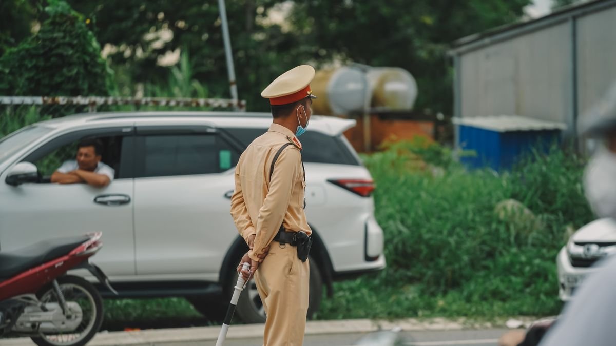 Agente de tránsito dirigiendo el flujo de vehículos en una vía urbana